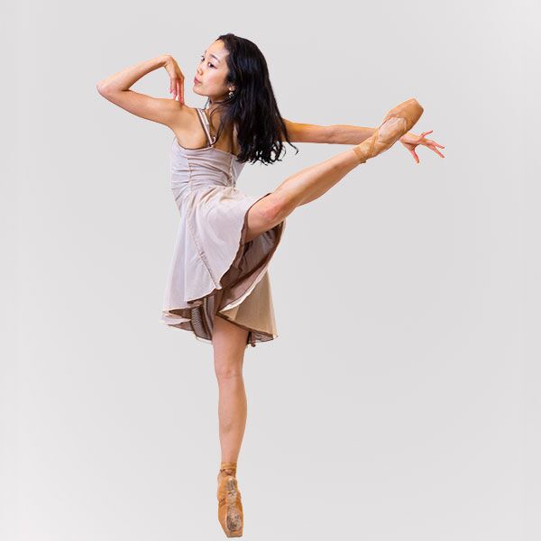 Dancer in attitude position looking backwards
